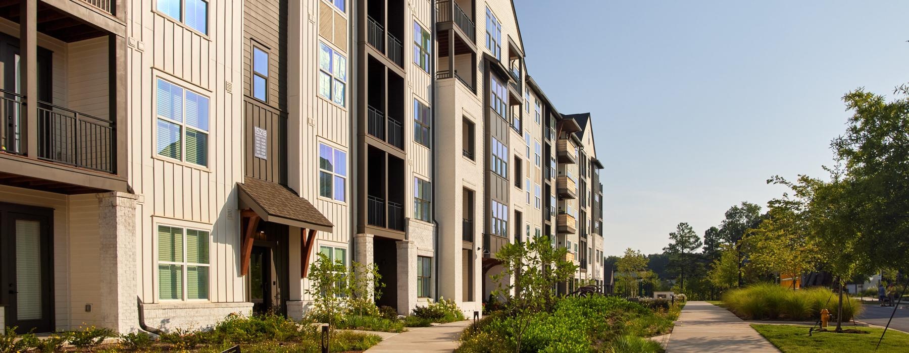 a building with a walkway and grass