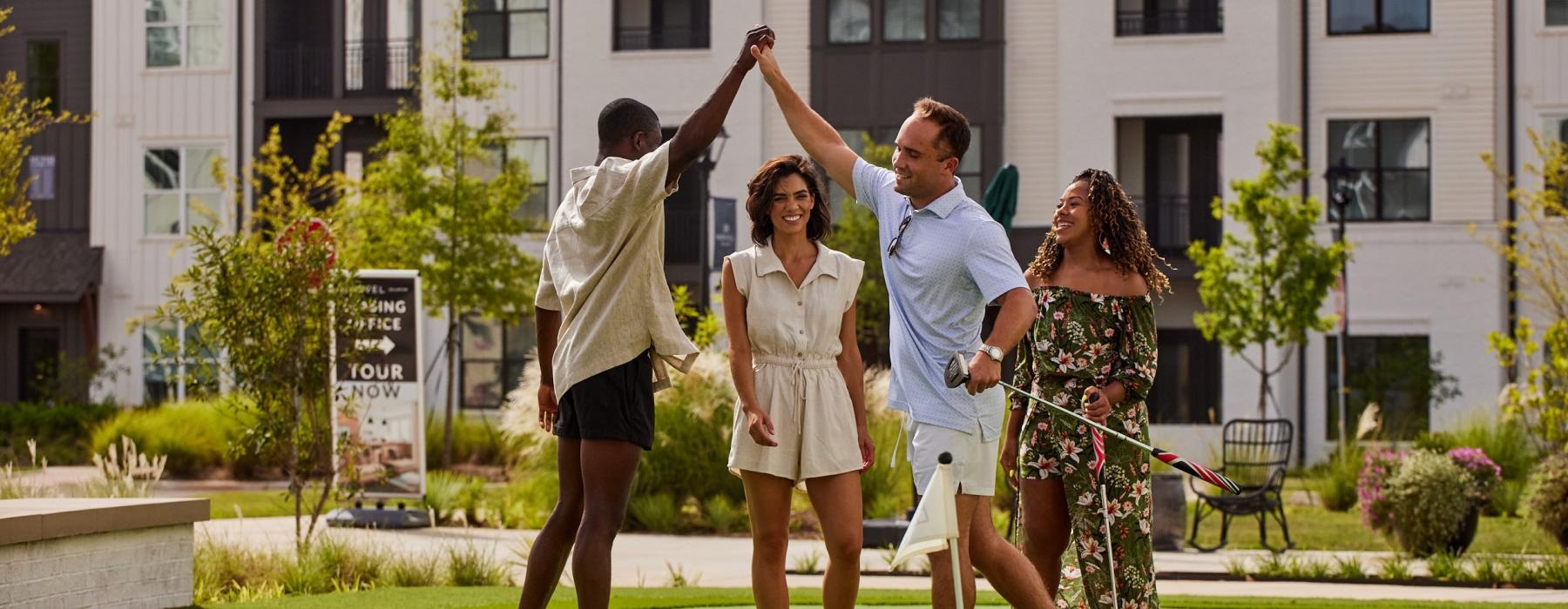 a group of people playing golf and high-fiving