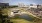 an outdoor amphitheatre with a pond in front of it