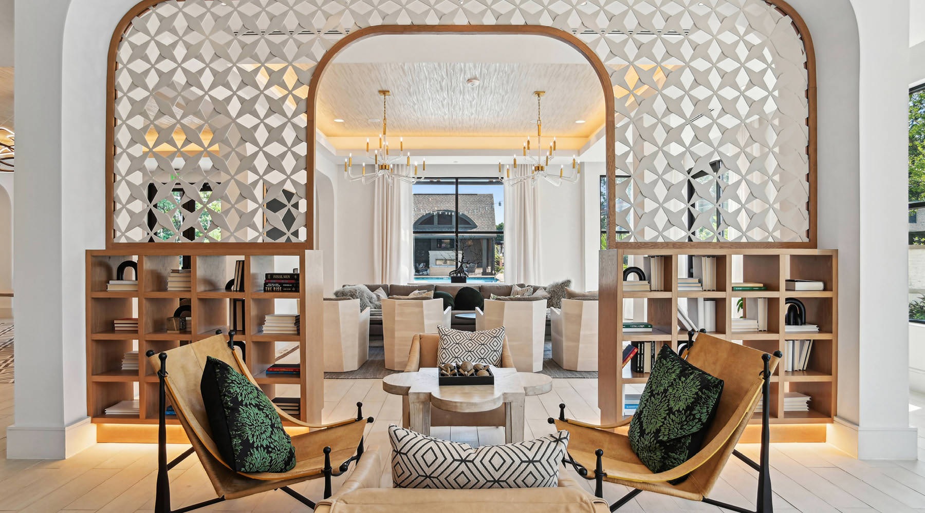 Unrivaled luxury. Unmatched convenience. a lounge area with bookcases